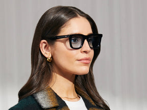 Model is wearing The RIZIK in Black in size 49 with Bel Air Blue Tinted Lenses