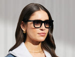 Model is wearing The RIZIK in Black in size 49 with American Grey Fade Tinted Lenses