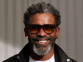 Model is wearing The RIZIK SUN in Olive Brown in size 49 with Chestnut Fade Tinted Lenses