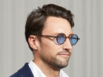 Model is wearing The SCOOCH SUN in Tobacco in size 46 with Celebrity Blue Tinted Lenses