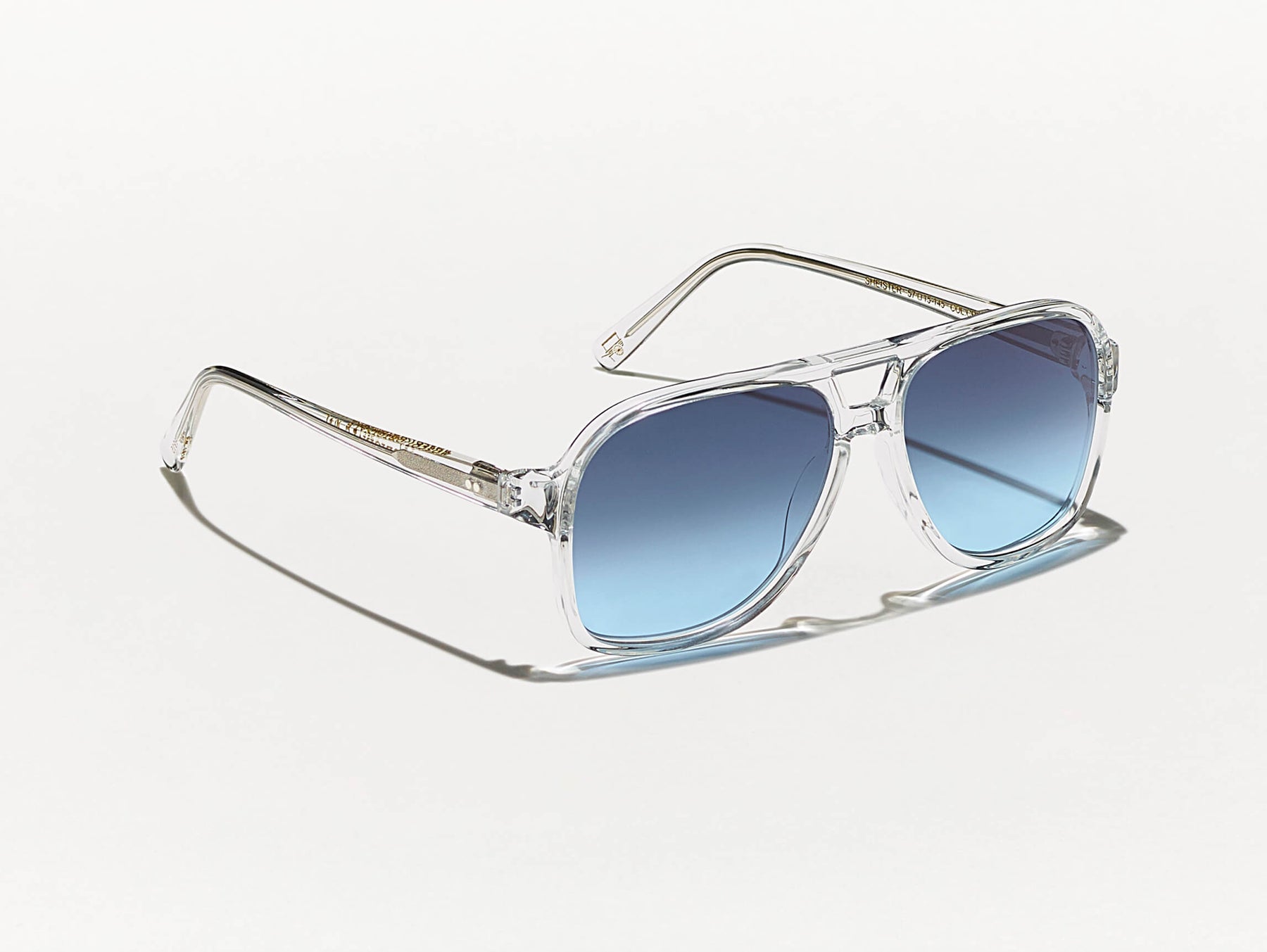 The SHEISTER SUN in Crystal with Denim Blue Tinted Lenses