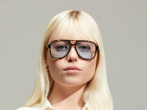 Model is wearing The SHEISTER SUN in Tortoise in size 57 with Bel Air Blue Tinted Lenses