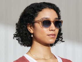 Model is wearing The SHIDDOCK SUN in Cinnamon in size 52 with Denim Blue Tinted Lenses