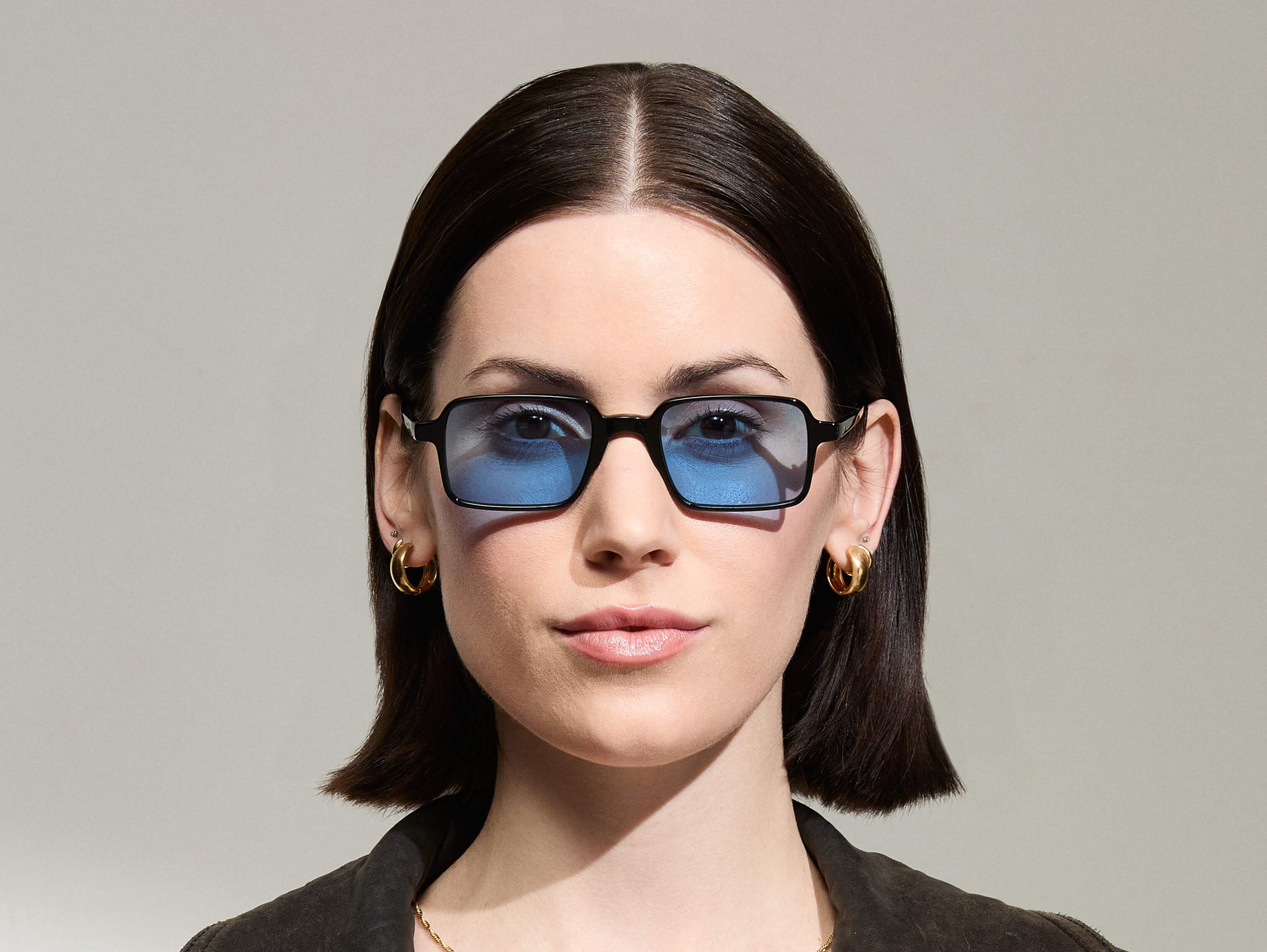 Model is wearing The SHINDIG Black in size 50 with Celebrity Blue Tinted Lenses