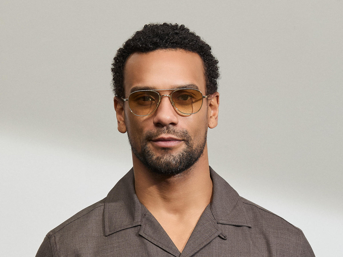 Model is wearing The SHMECKEL SUN in size 53 in Gold with Chestnut Fade Tinted Lenses