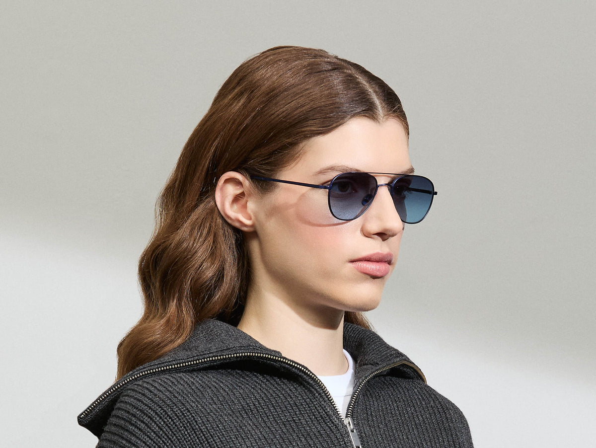 Model is wearing The SHMECKEL SUN in size 53 in Navy with Denim Blue Tinted Lenses