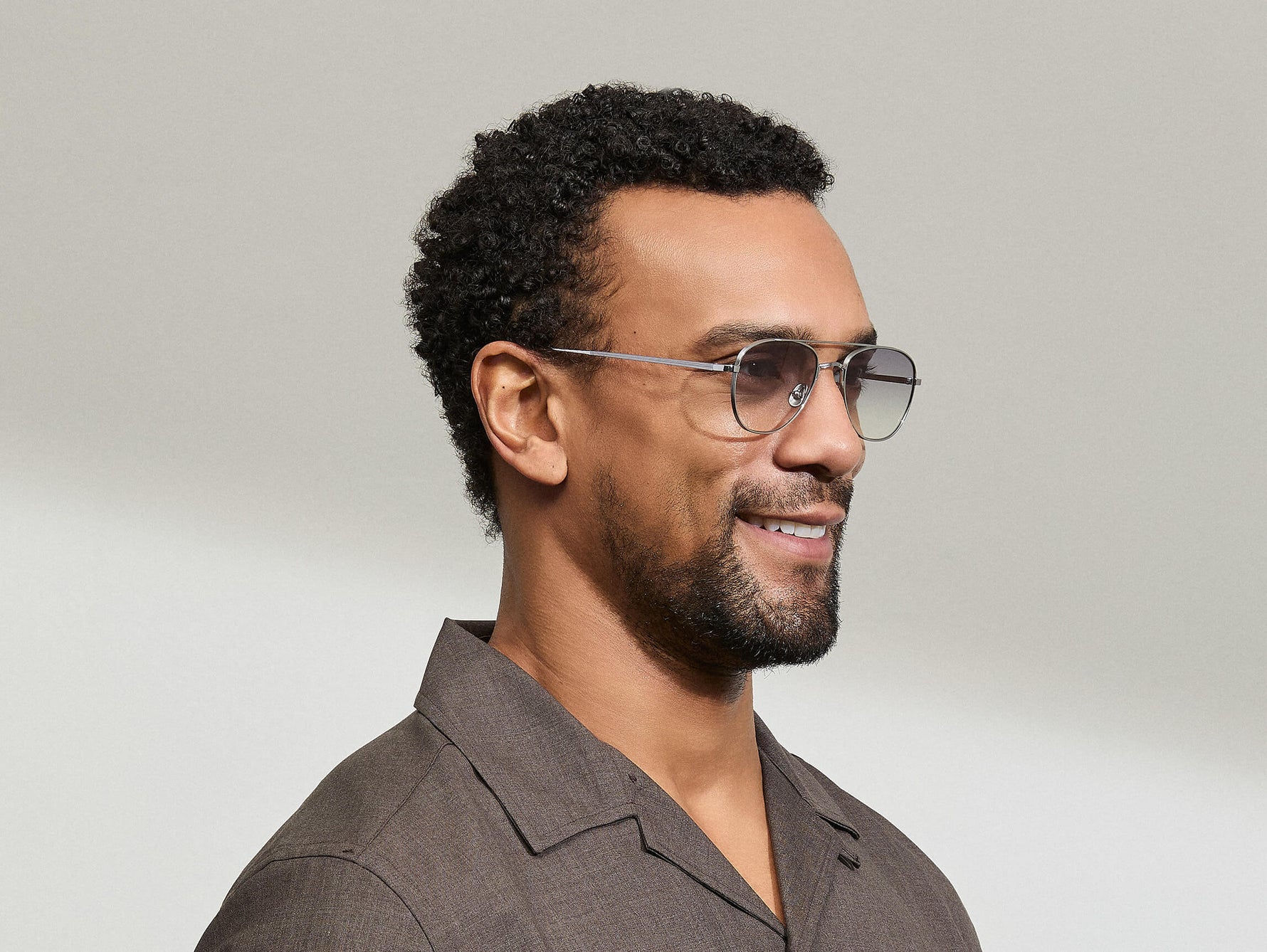 Model is wearing The SHMECKEL SUN in size 53 in Silver with American Grey Fade Tinted Lenses
