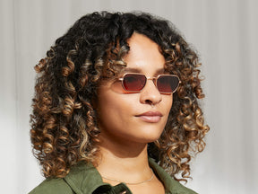 Model is wearing The SHMOOZ SUN in Rose in size 48 with Cabernet Tinted Lenses