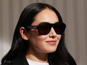 Model is wearing The SHVITZ SUN in Black in size 57 with Green Lenses