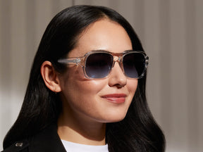 Model is wearing The SHVITZ SUN in Crystal in size 57 with Denim Blue Tinted Lenses