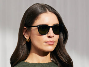 Model is wearing The TATAH SUN in Black in size 50 with G-15 Glass Lenses