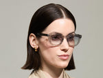 Model is wearing The TELENA in Grey/Light Grey in size 47 with American Grey Fade Tinted Lenses