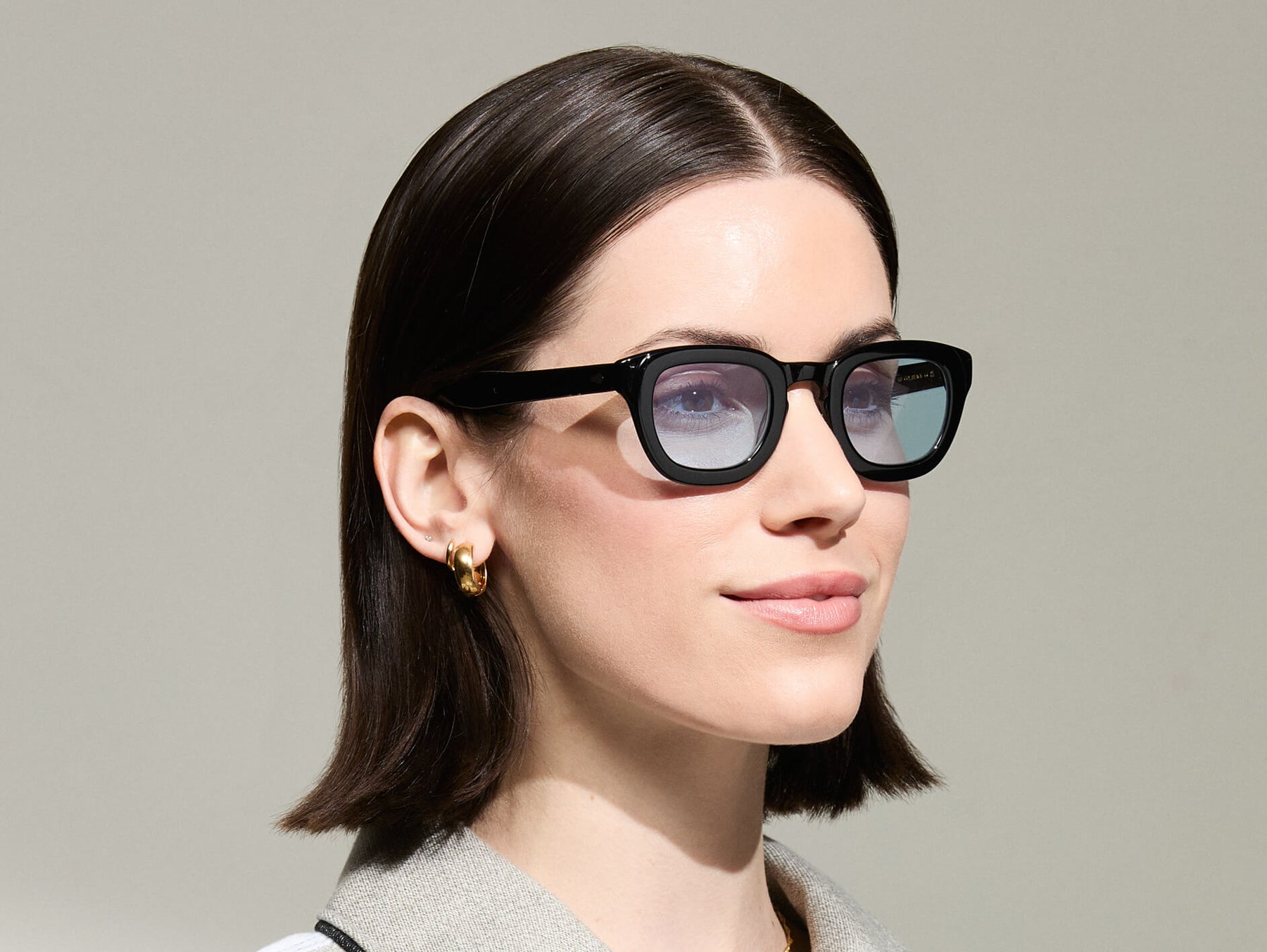 The Model is wearing The TELENA in Black in Size 44 with Bel Air Blue Tinted Lenses