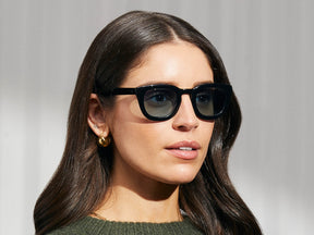 Model is wearing the TELENA SUN in Black in size 47 with Mineral Blue Glass Lenses