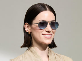 Model is wearing The TRAIF SUN in size 52 in Light Blue with Denim Blue Tinted Lenses