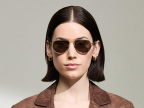 Model is wearing The TRAIF SUN in size 52 in Bamboo with G-15 Tinted Lenses