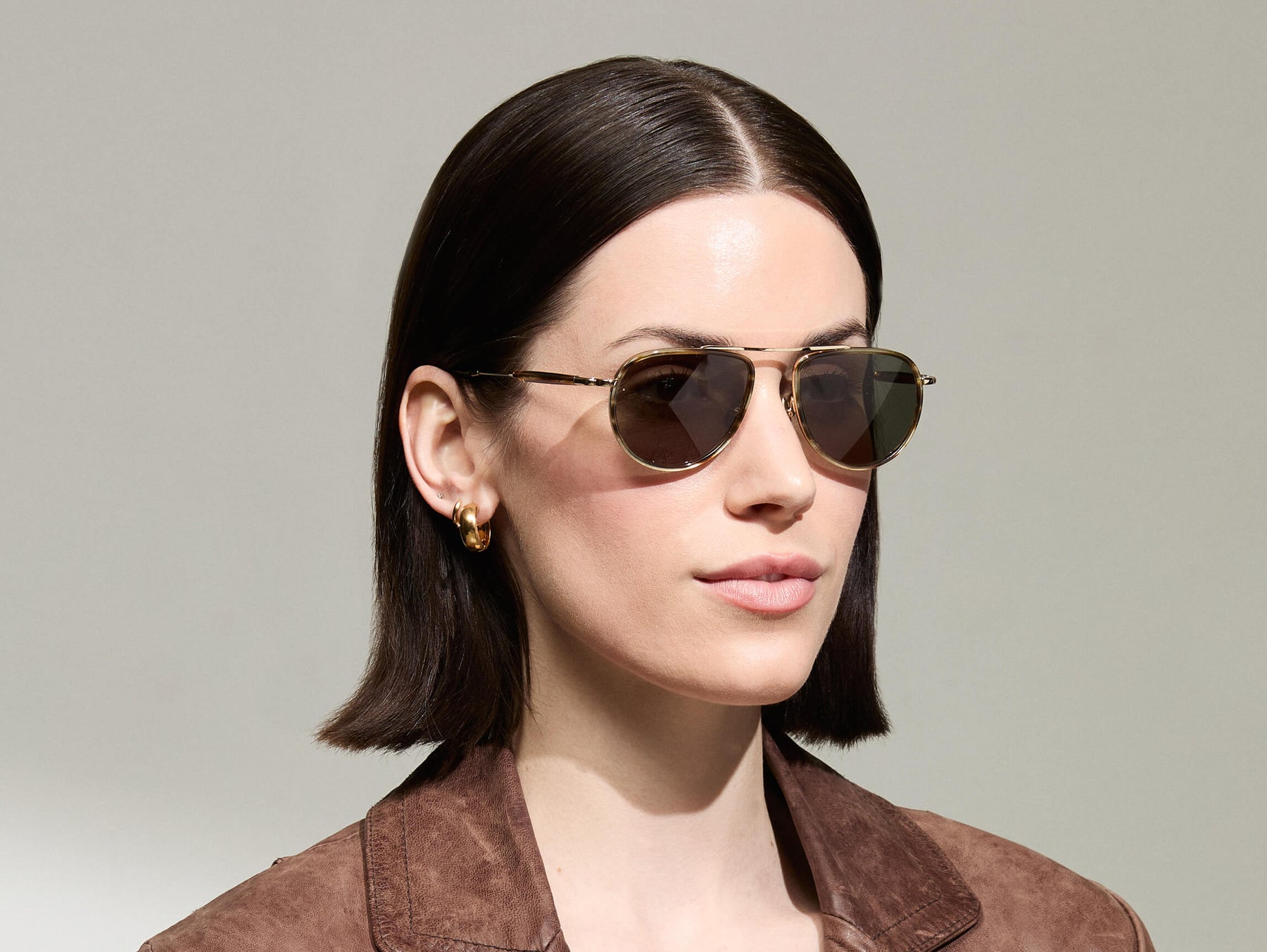Model is wearing The TRAIF SUN in size 52 in Bamboo with G-15 Tinted Lenses
