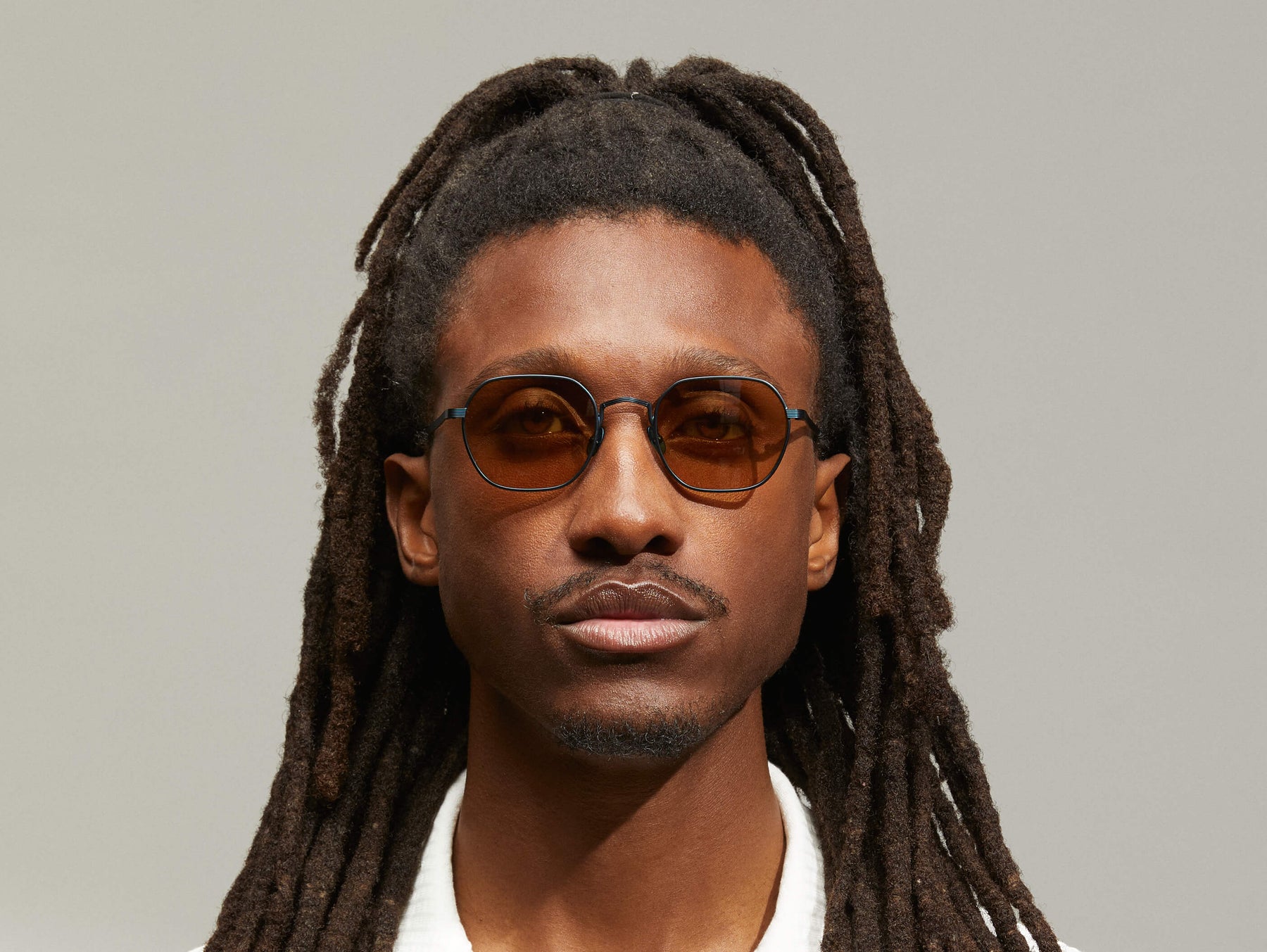 Model is wearing The UTZ SUN in size 50 in Navy with Amber Tinted Lenses