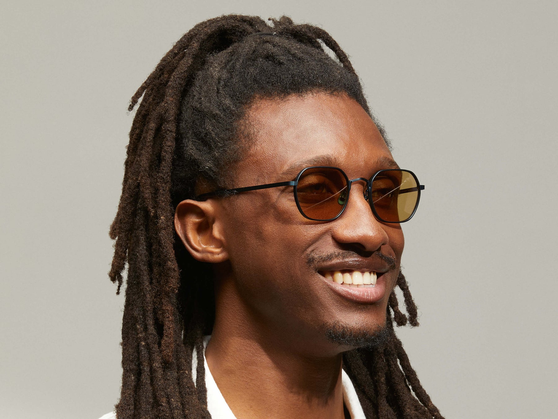 Model is wearing The UTZ SUN in size 50 in Navy with Amber Tinted Lenses