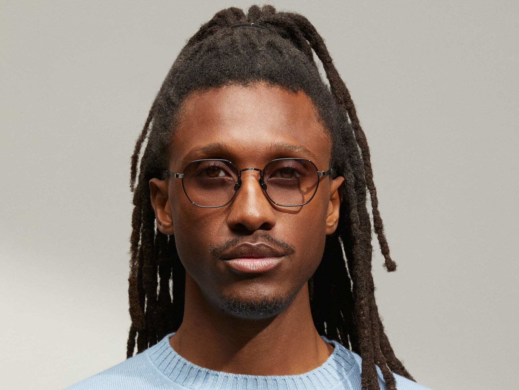 Model is wearing The UTZ SUN in size 50 in Pewter with American Grey Fade Tinted Lenses