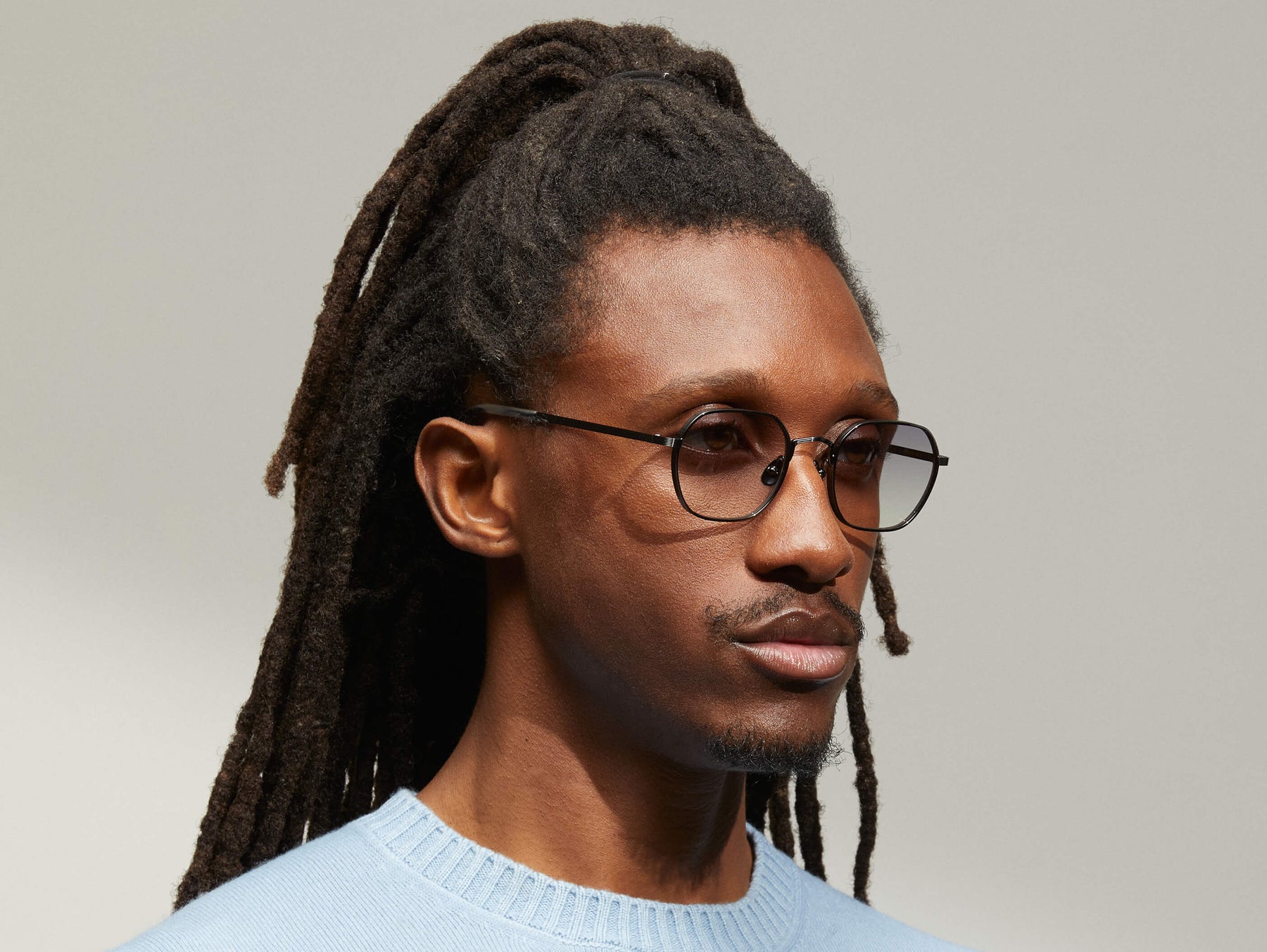 Model is wearing The UTZ SUN in size 50 in Pewter with American Grey Fade Tinted Lenses