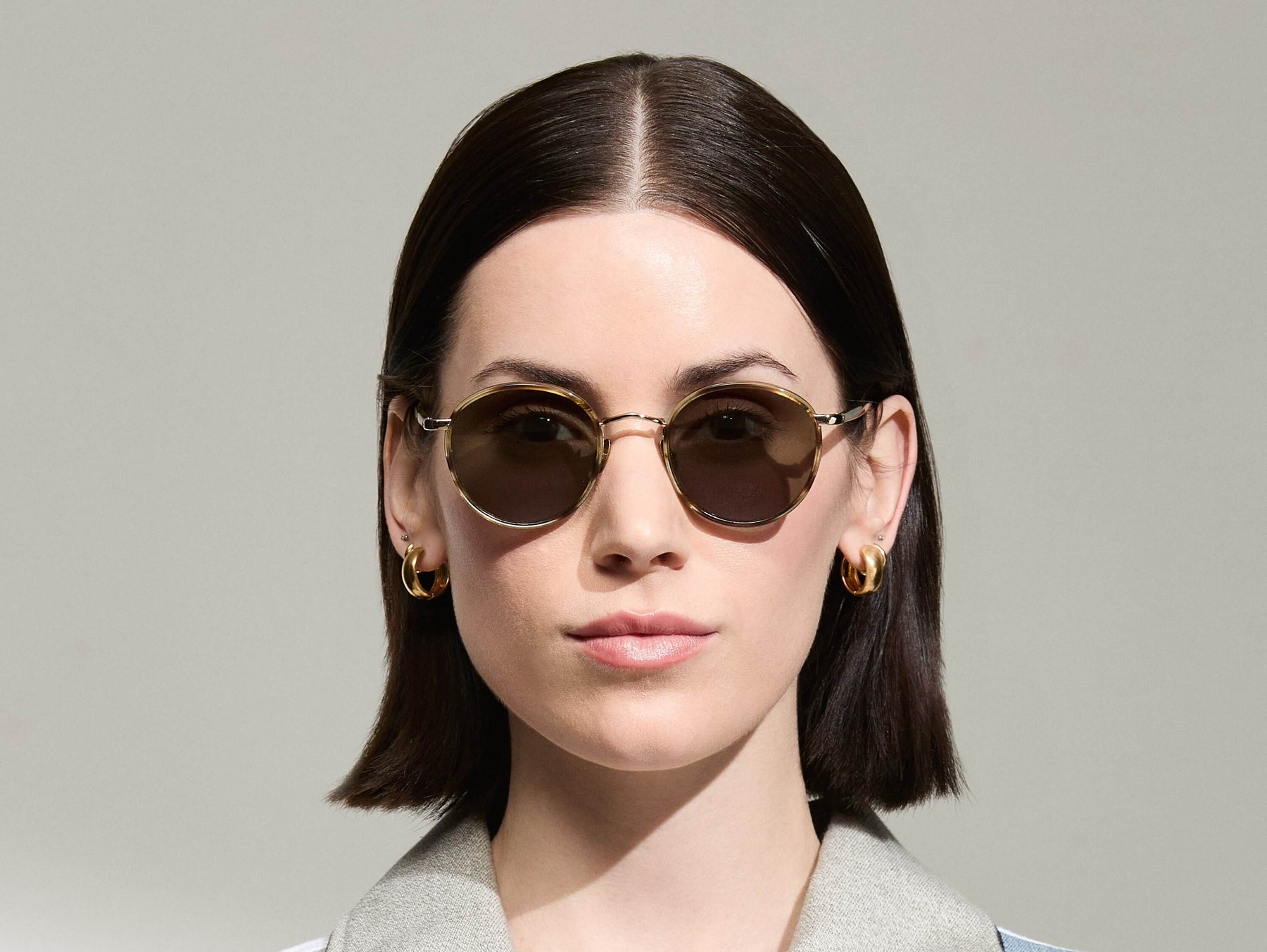 Model is wearing The ZEV SUN in Bamboo in size 49 with G-15 Tinted Lenses