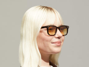 Model is wearing The ZISSEL SUN in size 49 in Dark Brown/Tortoise with Chestnut Fade Tinted Lenses