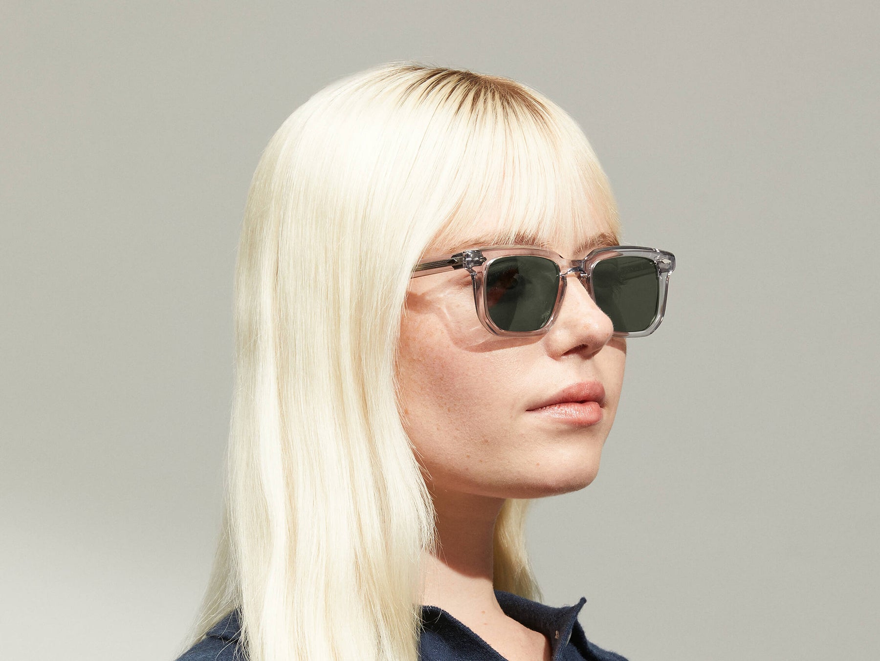 Model is wearing The ZISSEL SUN in size 49 in Light Grey with G-15 Tinted Lenses