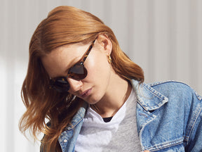 Model is wearing The AIDIM SUN in Classic Havana/Gunmetal in size 46 with Cosmitan Brown Glass Lenses