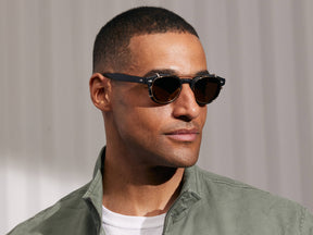 Model is wearing The CLIPTOSH in Gold in size 49 with Gold Mirror Lenses