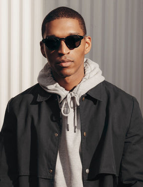 Model is wearing The CLIPTOSH in Matte Black in size 46 with G-15 Lenses