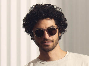 Model is wearing The CLIPZEN in Gold in size 49 with G-15 Lenses