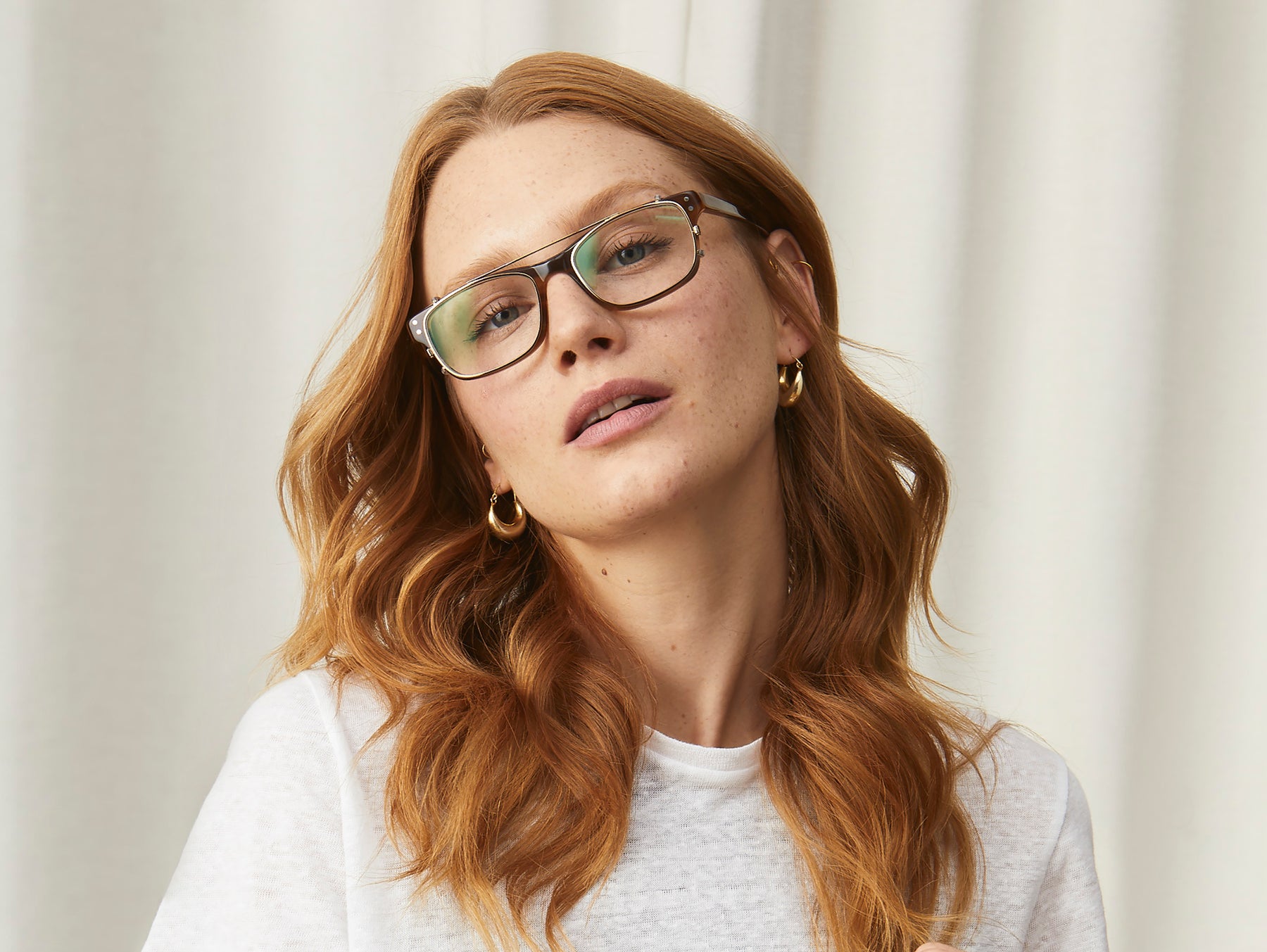 Model is wearing The ALEX CLIP in Brass in size 49 with Blue Protect Lenses