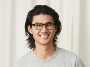 Model is wearing The ARTHUR CLIP in Brass in size 48 with Blue Protect Lenses