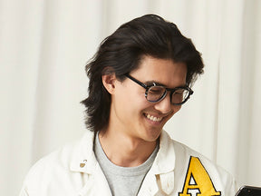 Model is wearing The ARTHUR CLIP in Brass in size 48 with Blue Protect Lenses