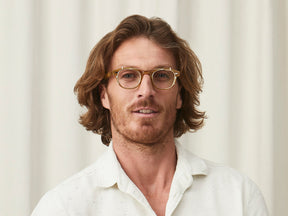 Model is wearing The CLIPTOSH in Gold in size 46 with Blue Protect Lenses