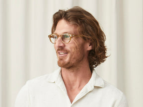 Model is wearing The CLIPTOSH in Gold in size 46 with Blue Protect Lenses