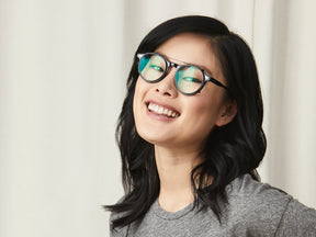 Model is wearing The CLIPZEN in Matte Black in size 49 with Blue Protect Lenses