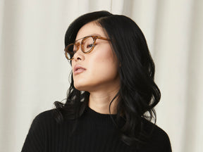 Model is wearing The FRANKIE CLIP in Brass in size 51 with Blue Protect Lenses