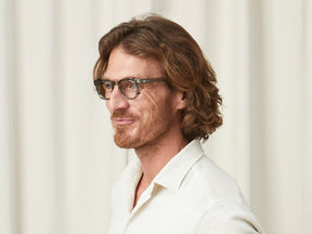 Model is wearing The GELT CLIP in Pewter in size 46 with Blue Protect Lenses