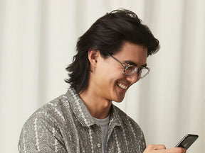 Model is wearing The SCHLEP CLIP in Gold in size 50 with Blue Protect Lenses