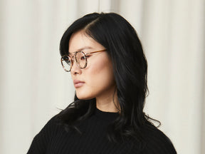 Model is wearing The ZEV CLIP in Gold in Size 49 with Blue Protect Lenses