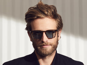 Model is wearing The DUDEL SUN in Bark in size 51 with Blue Glass Lenses