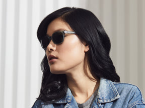 Model is wearing The EMIS SUN in Blue Smoke with G-15 Glass Lenses