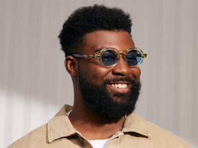 Model is wearing The FOYGEL SUN in Citron/Tortoise in size 46 with Celebrity Blue Tinted Lenses