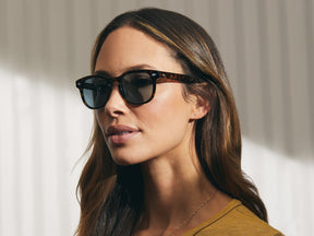 Model is wearing The GELT SUN in Tortoise in size 49 with Blue Glass Lenses