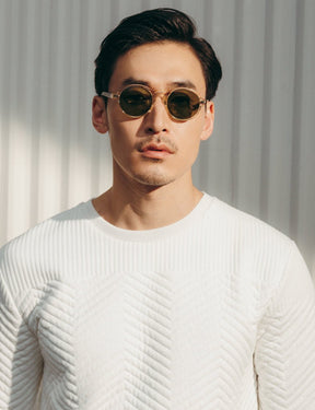 Model is wearing The GLICK SUN in Flesh/Tortoise in size 49 with Calibar Green Glass Lenses