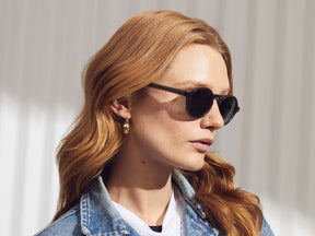 Model is wearing The GLICK SUN in Grey in size 49 with G-15 Glass Lenses