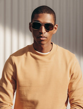 Model is wearing The HELDISH SUN in Gold in size 57 with Cosmitan Brown Glass Lenses