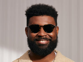 Model is wearing The KASH SUN in Tortoise/Gold in size 50 with G-15 Glass Lenses